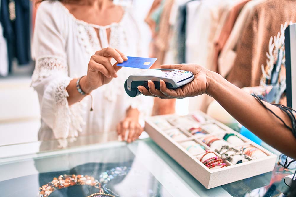 woman using credit card in retail shop