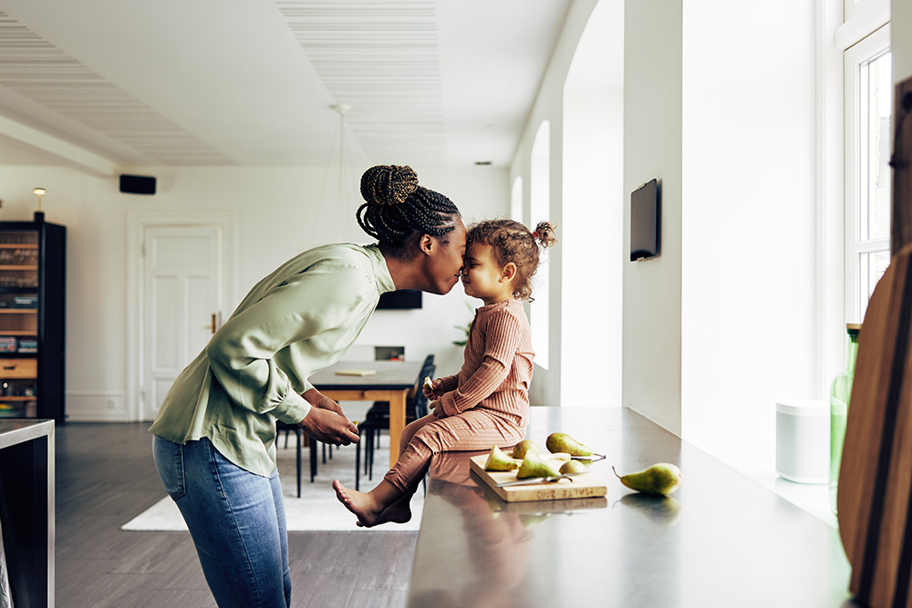 mom and daughter making food together in the kitchen together