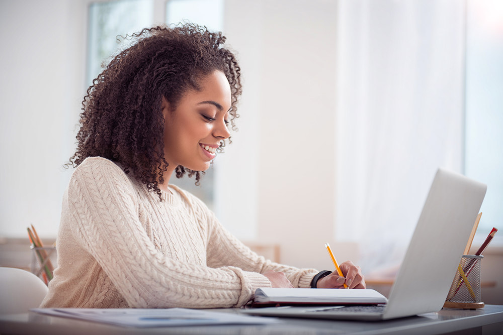 young female student working on laptop