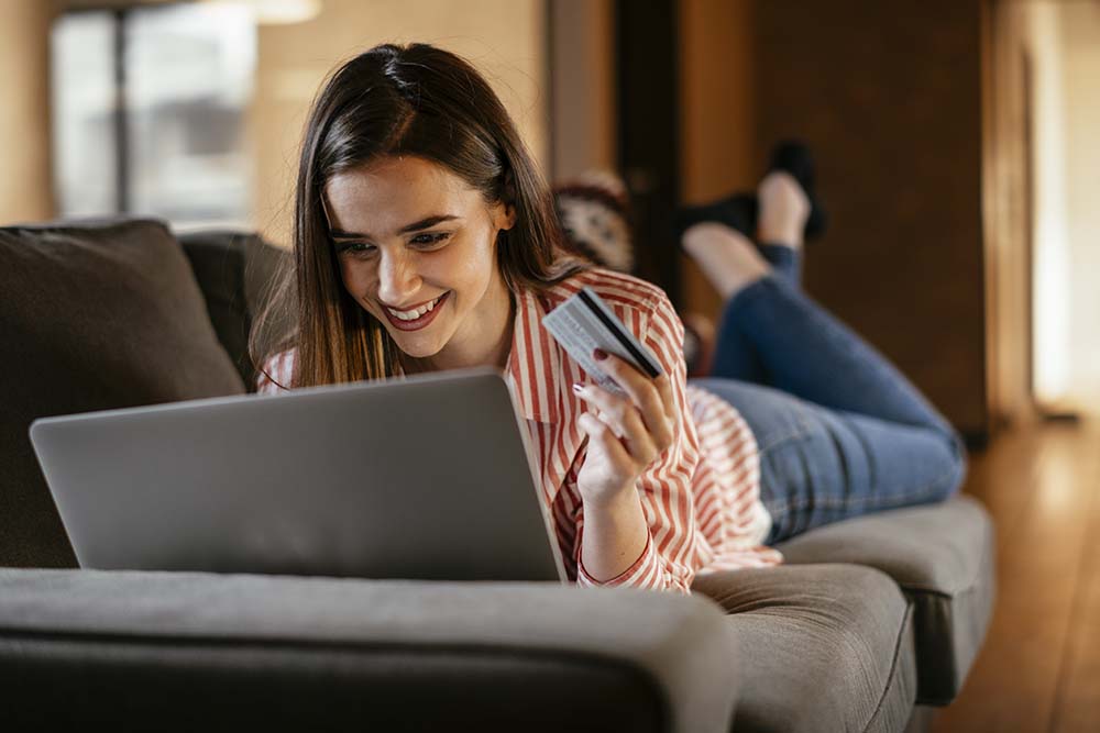 young woman making purchase online with credit card