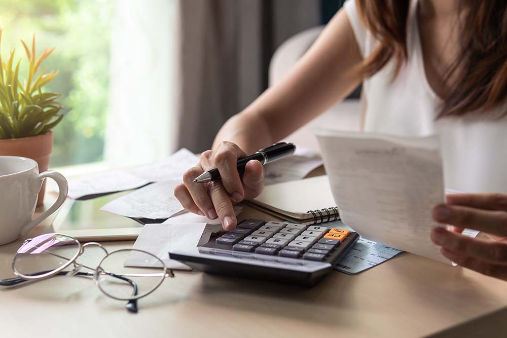 woman reviewing receipts and using a calculator