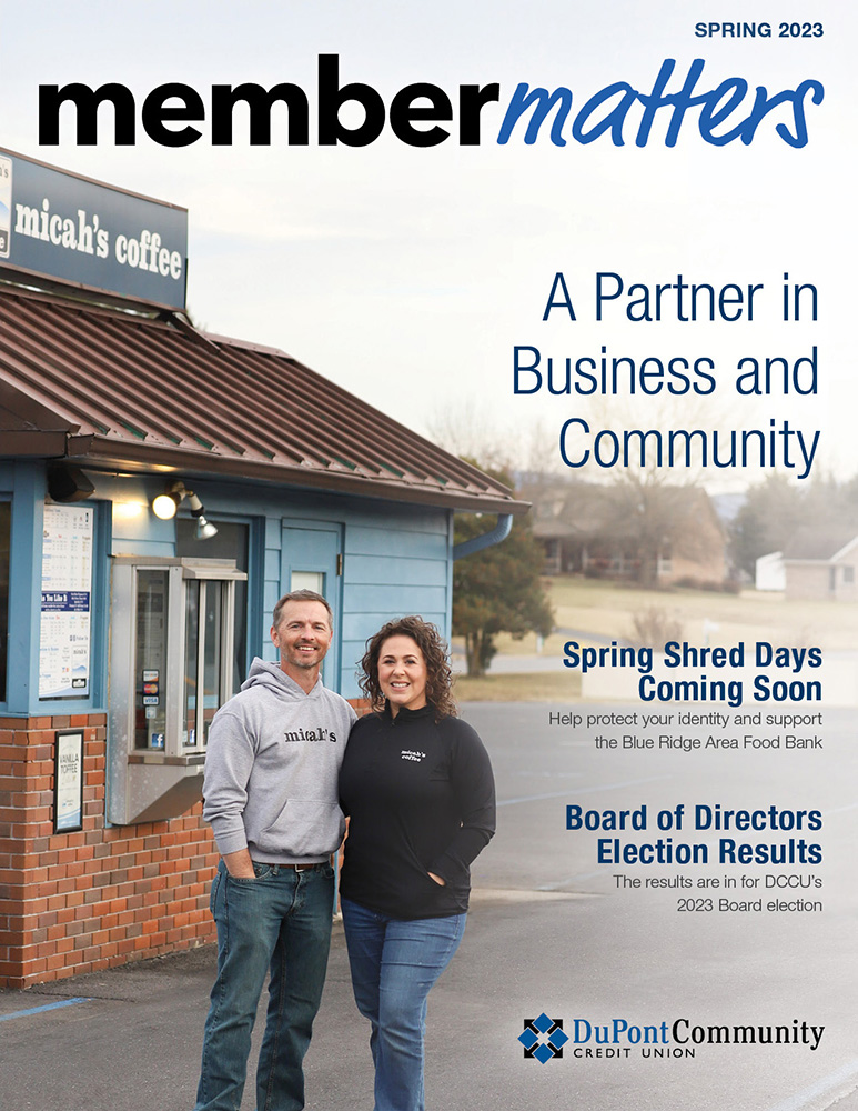 Bobby and Megan Collier, owners of micah's coffee, stand in front of their coffee stand, smiling