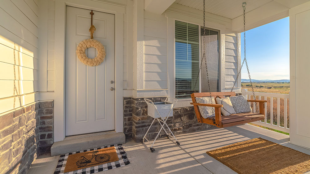 Front porch of home with a porch swing