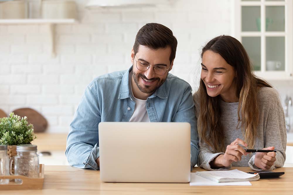 couple looking at computer together at table