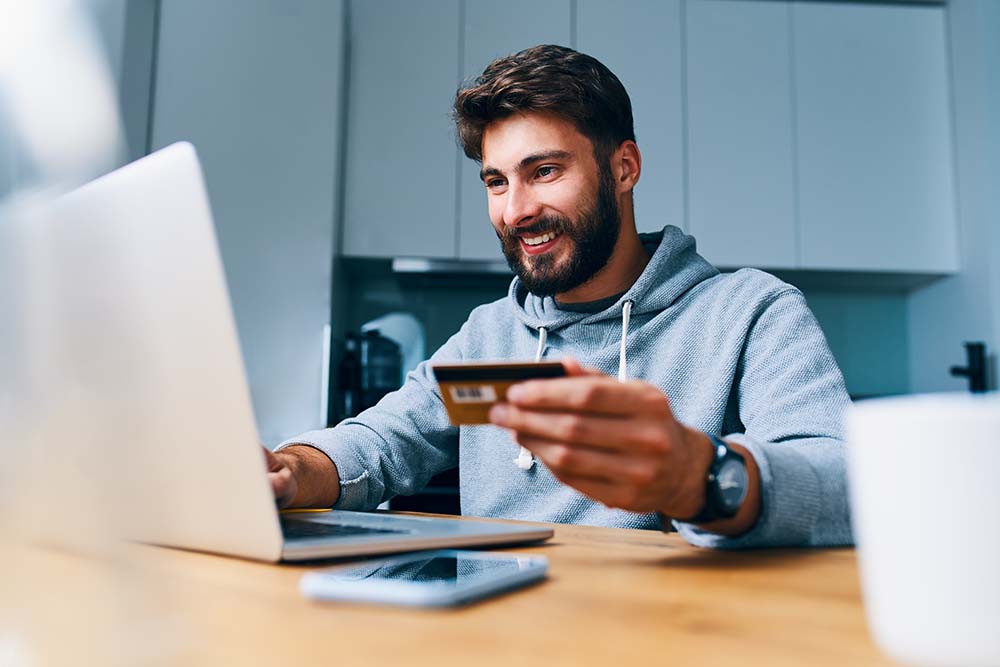 man shopping online with a credit card