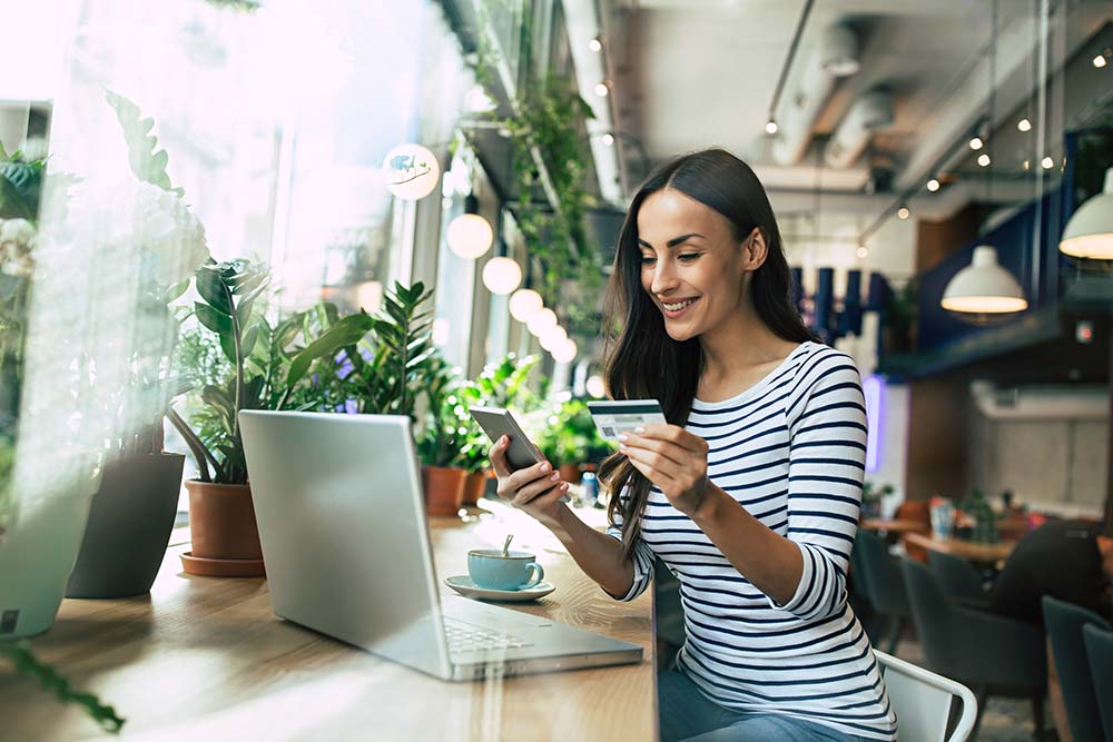 woman making a purchase on phone with a credit card