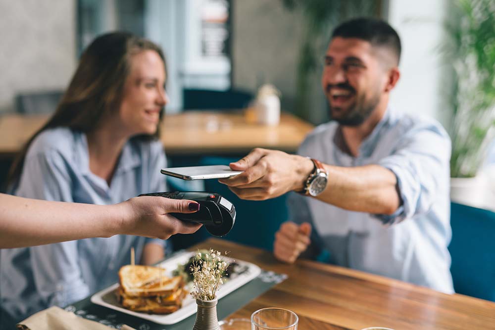 couple paying for meal using digital wallet